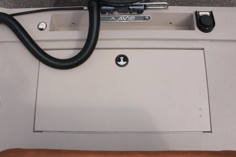 Slide: The Image of Avid 18 Rogue CC 2025 boat deck with storage compartment and hose. - 12