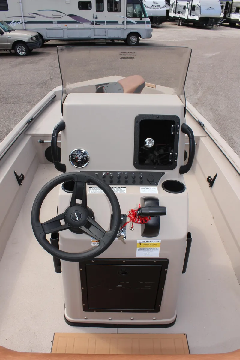 Slide: The Image of 2025 Avid 18 Rogue CC boat console with steering wheel and controls. - 15