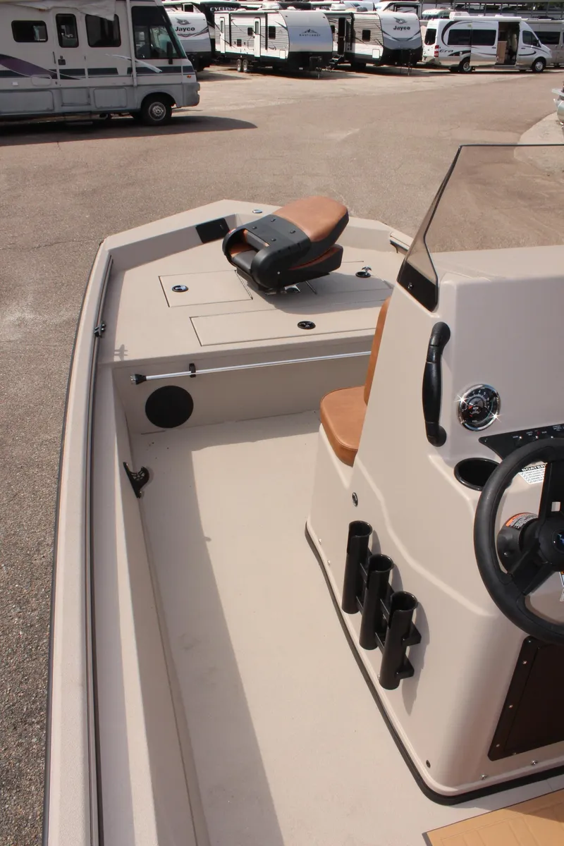 Slide: The Image of 2025 Avid 18 Rogue CC boat interior with steering wheel and seating. - 17