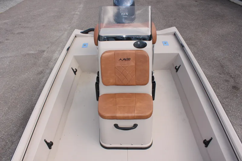 Slide: The Image of Avid 18 Rogue CC 2025 boat interior with tan seating and console. - 26