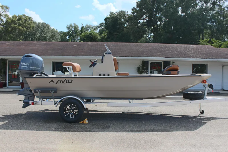 Slide: The Image of 2025 Avid 18 Rogue CC boat on trailer, parked outdoors. - 6