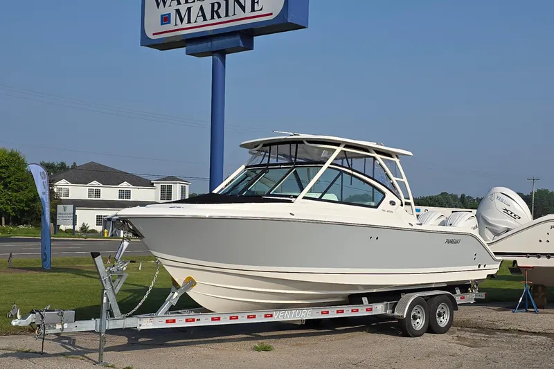 The Image of 2025 Pursuit DC 266 Dual Console boat on trailer at Walsh Marine dealership. - 0