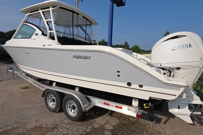 Slide: The Image of 2025 Pursuit DC 266 Dual Console boat on trailer with Yamaha engine. - 3