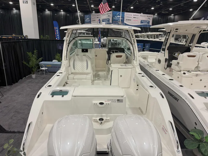 Slide: The Image of 2025 Pursuit DC 266 Dual Console boat displayed at an indoor exhibition. - 5