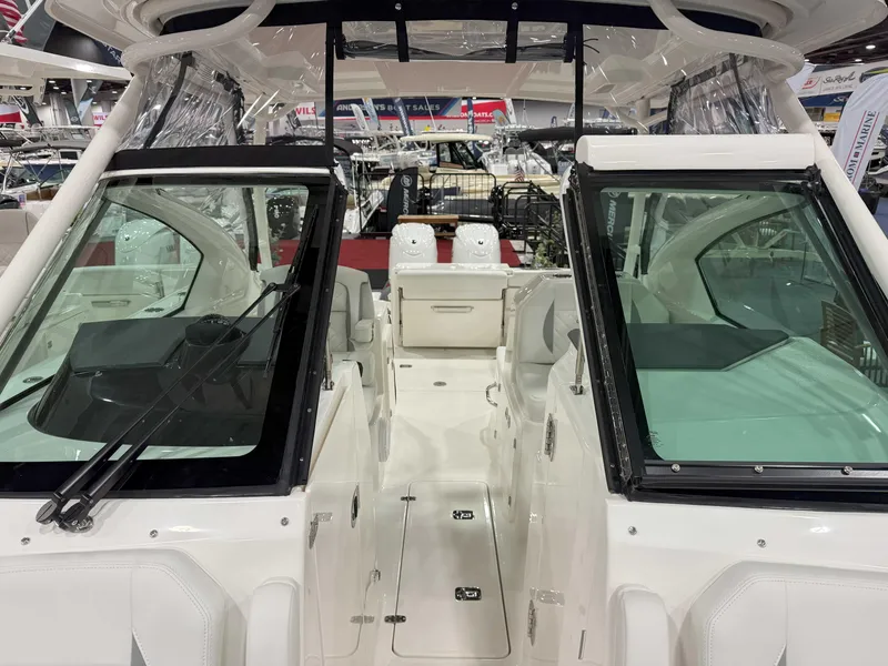 Slide: The Image of 2025 Pursuit DC 266 Dual Console boat interior with seating and windshield. - 9