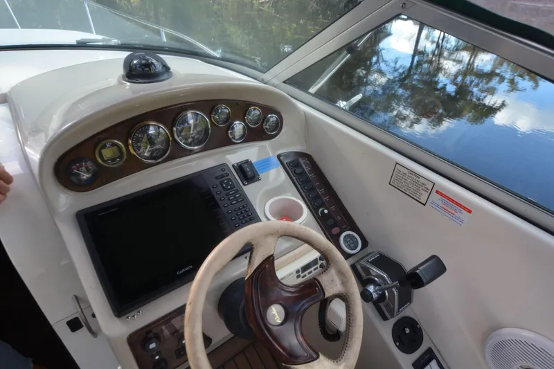 Slide: The Image of 1999 Rinker 270 Fiesta Vee boat dashboard with steering wheel and control panel. - 5