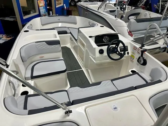 Slide: The Image of 2025 Bayliner Element M17 boat interior with modern seating and steering console. - 2