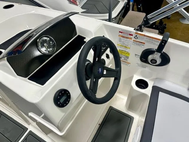 Slide: The Image of 2025 Bayliner Element M17 boat dashboard with steering wheel and control panel. - 6