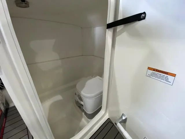 Slide: The Image of Interior of 2025 Sea Ray SPX 230 Outboard with toilet. - 15