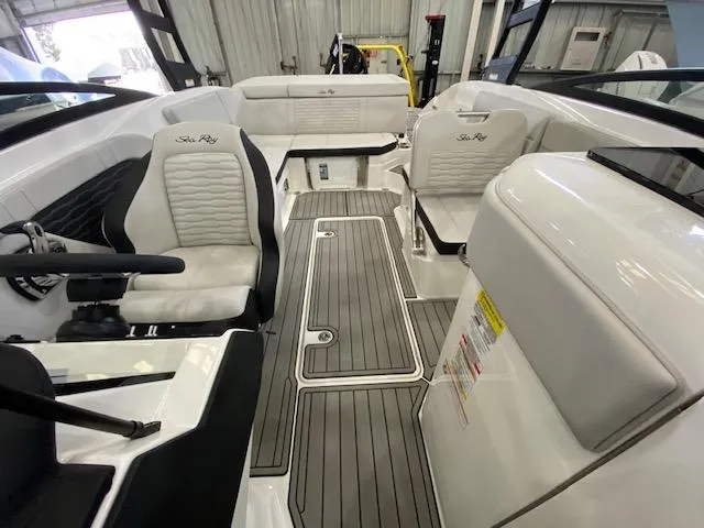 Slide: The Image of Interior of 2025 Sea Ray SPX 230 Outboard boat, featuring modern seating and flooring. - 16