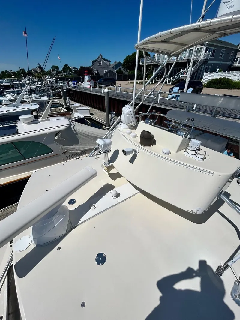 Slide: The Image of 1985 Viking Express boat docked at marina under clear blue sky. - 11