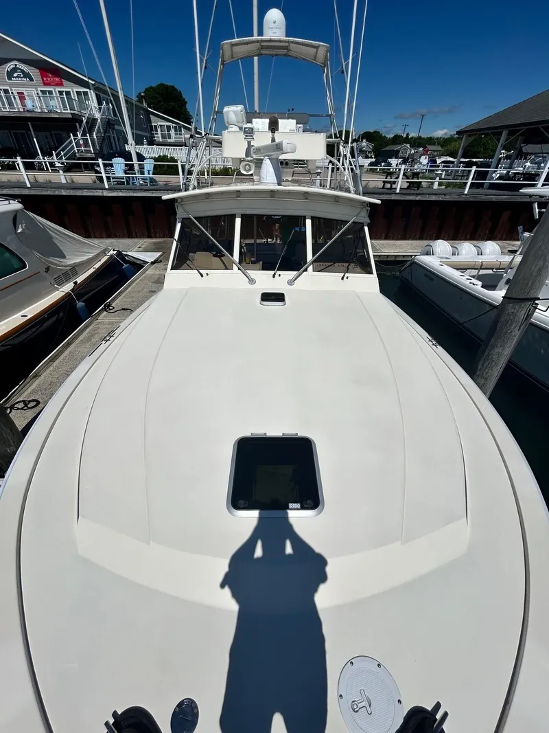 Slide: The Image of 1985 Viking Express boat docked at a marina under clear blue skies. - 13