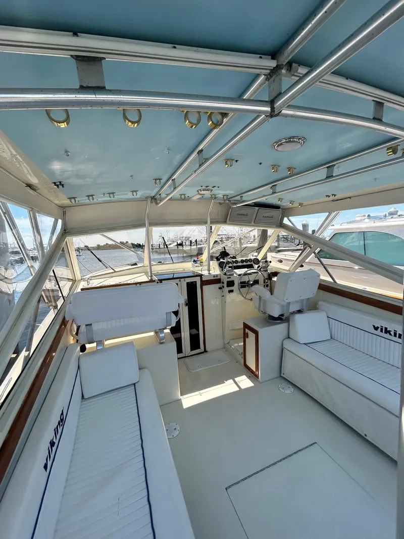 Slide: The Image of 1985 Viking Express boat interior with seating, steering, and blue ceiling. - 15