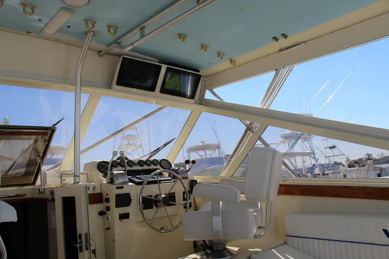 Slide: The Image of Interior of 1985 Viking Express boat with steering wheel and navigation equipment. - 19