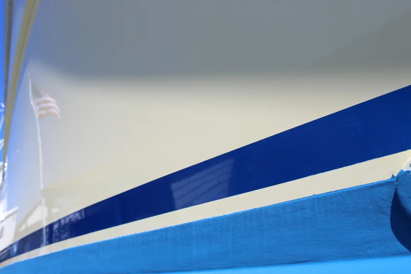Slide: The Image of Close-up of 1985 Viking Express boat hull with blue and white stripes. - 6