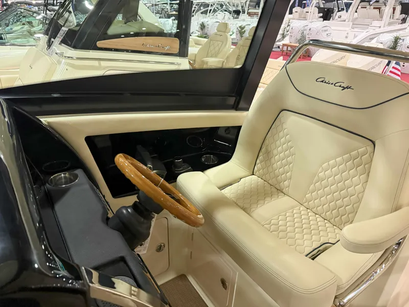 Slide: The Image of Luxurious interior of 2025 Chris-Craft Calypso 32 with elegant seating and wooden steering wheel. - 5