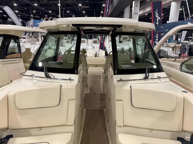 Slide: The Image of 2025 Chris-Craft Calypso 32 boat interior at a boat show, showcasing seating and design. - 7