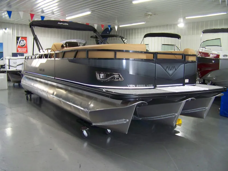 The Image of 2025 Avalon Venture 85 Versatile Rear Bench pontoon boat in showroom, sleek design, modern features. - 0