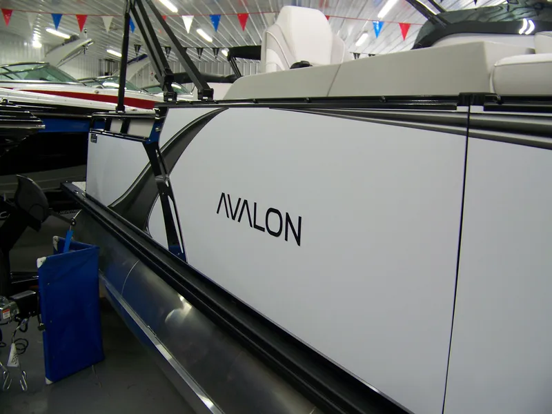 Slide: The Image of 2025 Avalon LSZ23CRB pontoon boat displayed indoors with sleek design and modern features. - 3