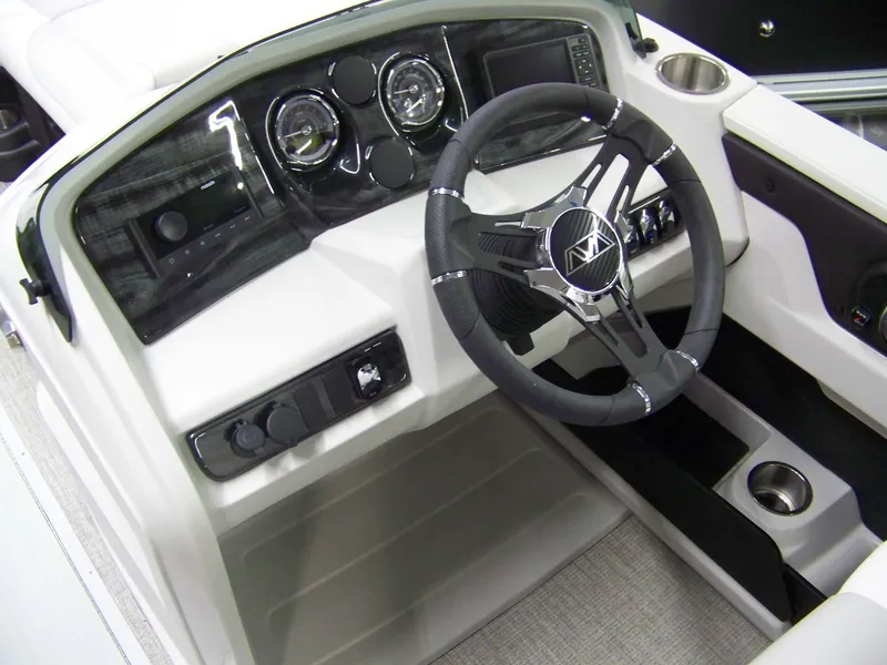 Slide: The Image of 2025 Avalon LSZ23CRB boat dashboard with steering wheel and control panel. - 4