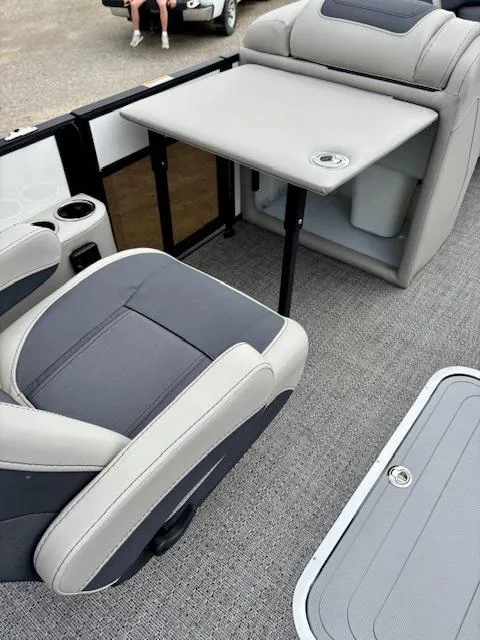 Slide: The Image of 2025 Barletta C22UC boat interior with seating and table setup. - 10