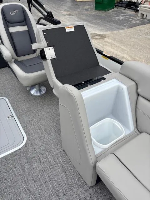 Slide: The Image of 2025 Barletta C22UC boat interior with gray seating and built-in storage compartment. - 11