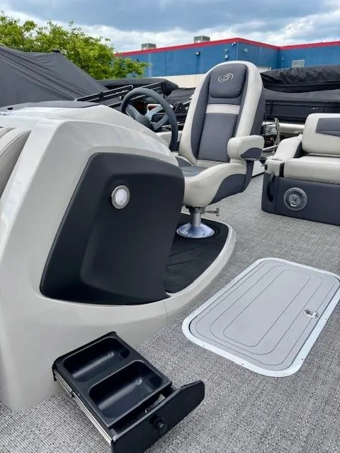 Slide: The Image of 2025 Barletta C22UC boat interior with captain's chair and sleek dashboard design. - 12