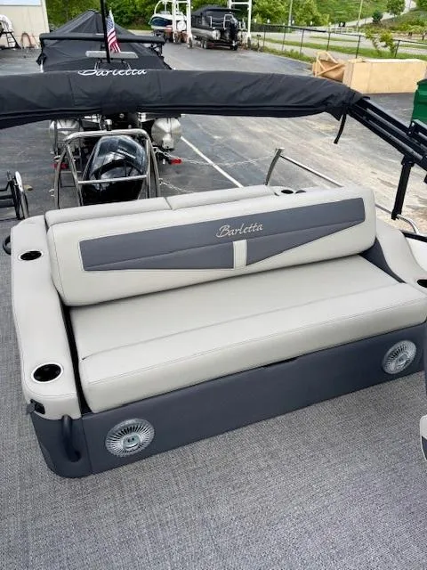 Slide: The Image of 2025 Barletta C22UC pontoon boat with cushioned seating and sleek design. - 15