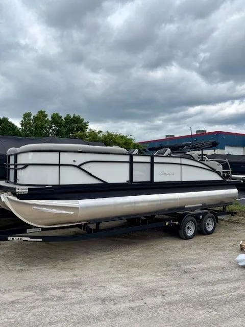Slide: The Image of 2025 Barletta C22UC pontoon boat on trailer under cloudy sky. - 4