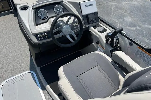 Slide: The Image of 2025 Barletta C22UC boat cockpit with steering wheel and Simrad display. - 8