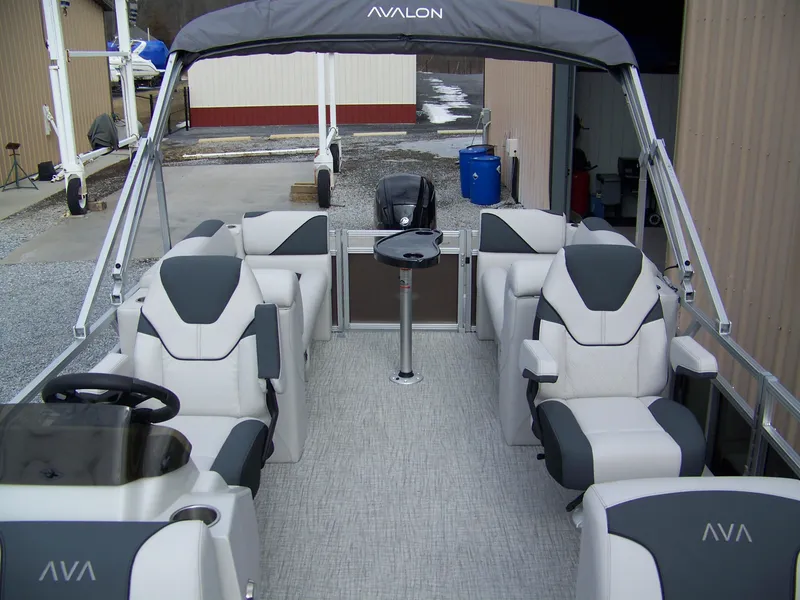 Slide: The Image of 2025 Avalon Venture 21QL pontoon boat interior with gray seating and canopy. - 3