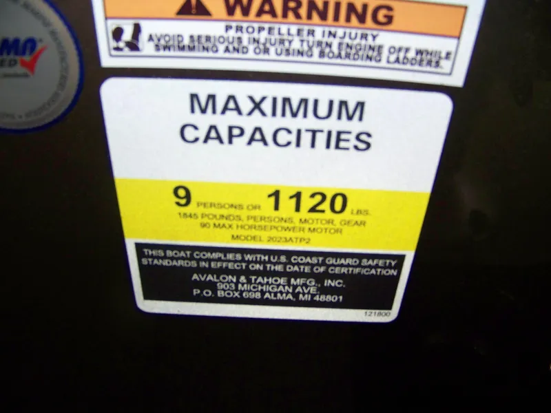 Slide: The Image of Warning label on Avalon Venture 21QL boat, 2025 model, showing maximum capacity of 9 persons or 1120 lbs. - 7