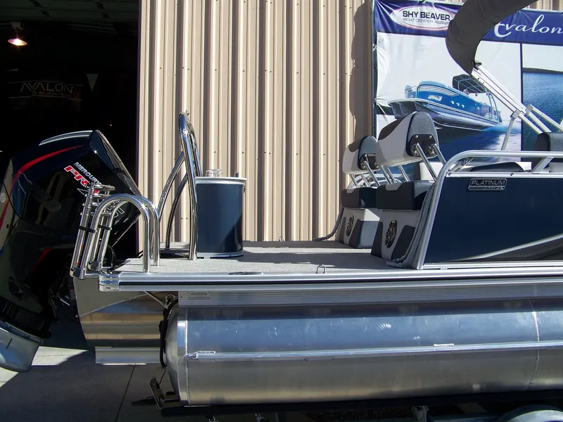 Slide: The Image of 2025 Avalon LSZ25QLS pontoon boat with sleek design and modern features, displayed in a showroom. - 2