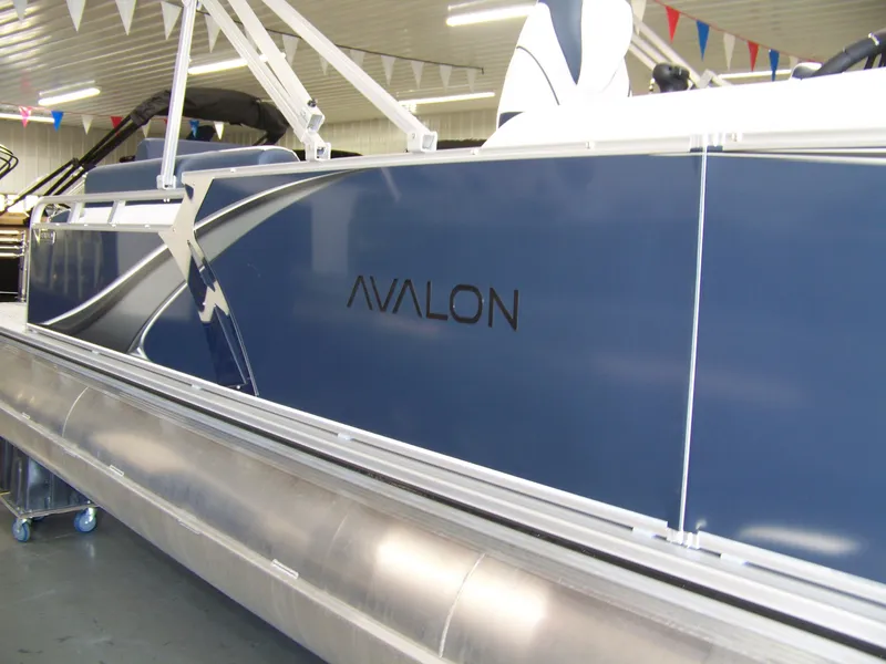 Slide: The Image of 2025 Avalon LSZ25QLS pontoon boat, sleek blue design in showroom. - 4