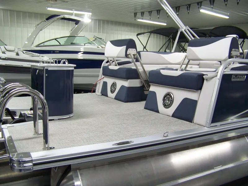 Slide: The Image of 2025 Avalon LSZ25QLS pontoon boat with stylish seating in a showroom. - 6