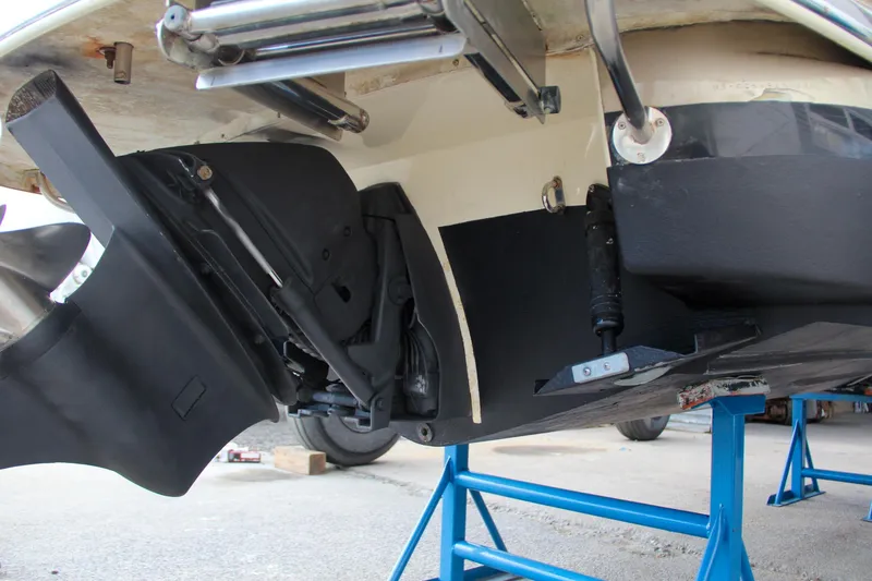 Slide: The Image of 2014 Chris-Craft Capri 21 boat with wooden deck and propeller, docked in a marina. - 13