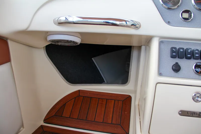 Slide: The Image of 2014 Chris-Craft Capri 21 boat interior with classic dashboard and wooden accents. - 22