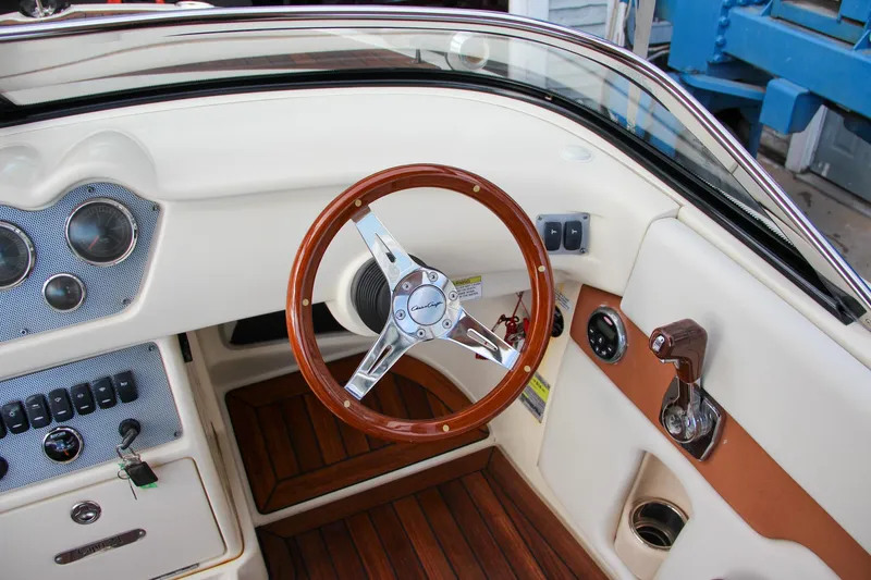 Slide: The Image of Dashboard of a 2014 Chris-Craft Capri 21 boat with Gussi Italia steering wheel cover. - 25