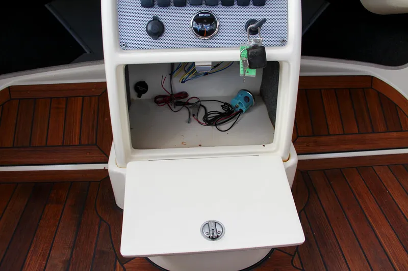 Slide: The Image of Dashboard of a 2014 Chris-Craft Capri 21 boat with wooden accents and control panel. - 29