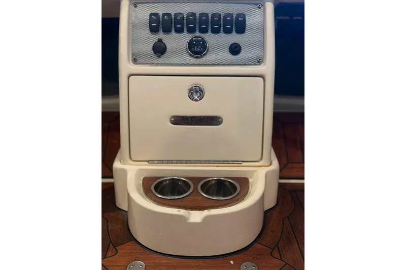 Slide: The Image of 2014 Chris-Craft Capri 21 interior with luxurious white leather seating and wooden accents. - 3