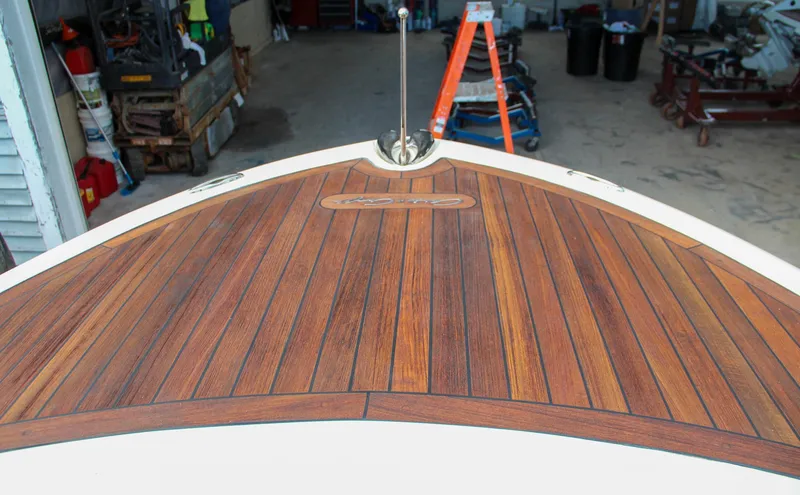 Slide: The Image of 2014 Chris-Craft Capri 21 boat with wooden deck and chrome horn detail. - 33