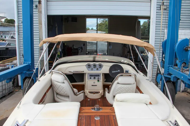 Slide: The Image of 2014 Chris-Craft Capri 21 interior with wooden steering wheel and classic dashboard design. - 4