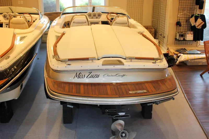 Slide: The Image of 2014 Chris-Craft Capri 21 boat in showroom, rear view with teak deck. - 43