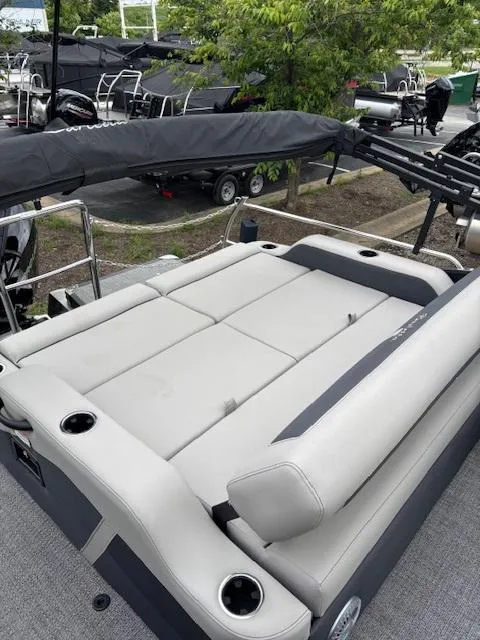 Slide: The Image of 2025 Barletta C24UC pontoon boat with spacious seating and sleek design. - 11