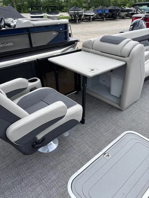 Slide: The Image of 2025 Barletta C24UC pontoon boat interior with seating and table setup. - 4