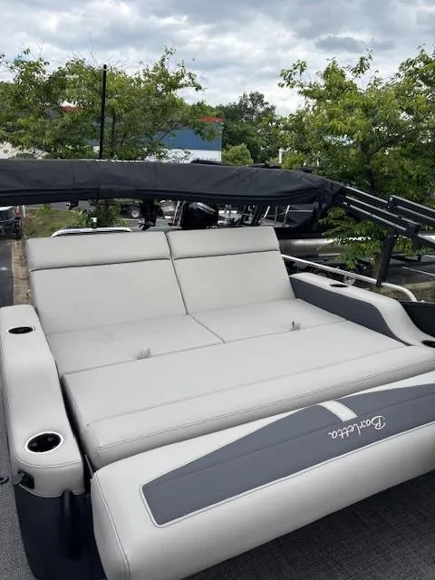 Slide: The Image of 2025 Barletta C24UC pontoon boat with spacious seating and sleek design. - 6