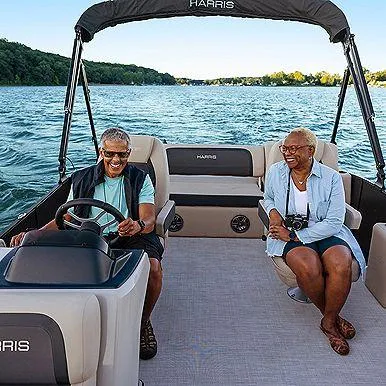Slide: The Image of Elderly couple enjoying a ride on a 2025 Harris Cruiser 210 FC boat. - 8