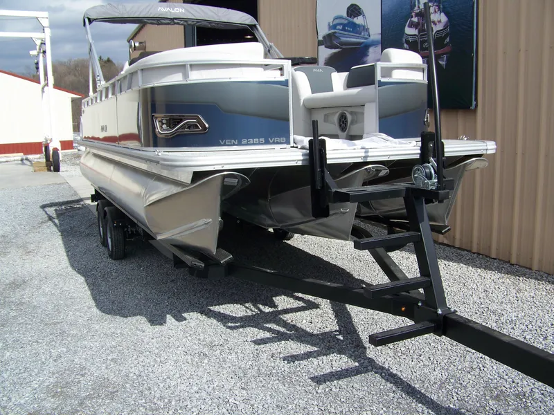 Slide: The Image of 2025 Avalon Venture 85 23VRB pontoon boat on trailer, outdoor display. - 2