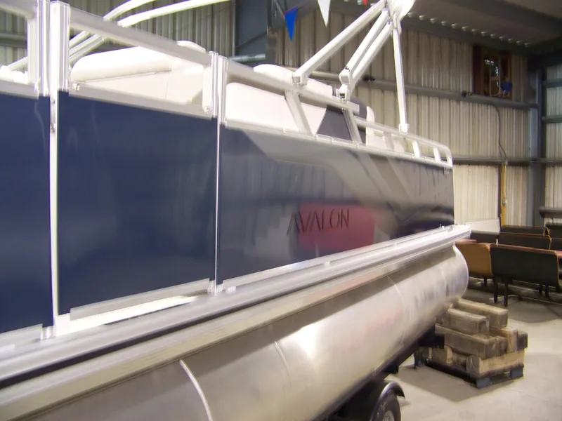 Slide: The Image of 2025 Avalon Venture 85 23VRB pontoon boat in a storage facility. - 3