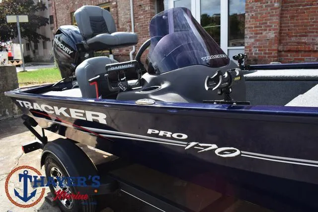 Slide: The Image of 2019 Tracker Pro 170 boat with Mercury engine and Garmin equipment, parked outdoors. - 32